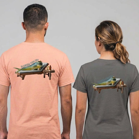 Two models shown from the back wearing matching graphic t-shirts. The man wears a peach-colored t-shirt and the woman wears a dark gray t-shirt, both featuring a graphic of a Florida fishing boat on the back.